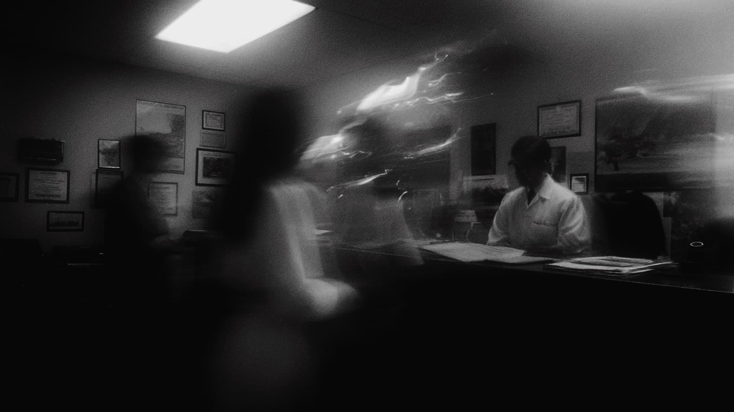 Black-and-white photograph of a busy dental front desk